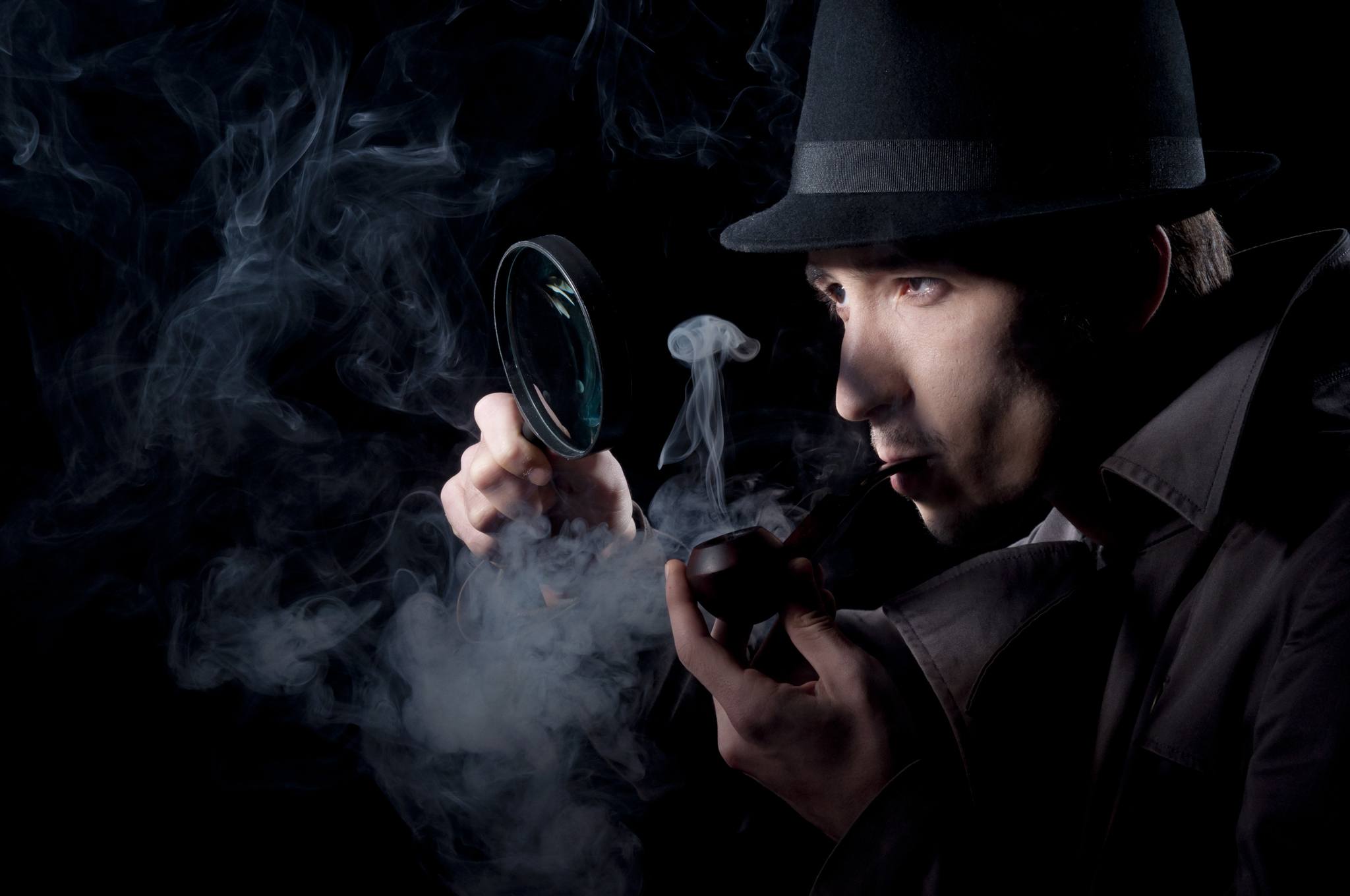 Private,Detective,Searching,For,Information,,Isolated,On,A,Black,Background