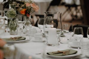Formal dinner table setting with candlelight and elegant place settings for murder mystery dinner event